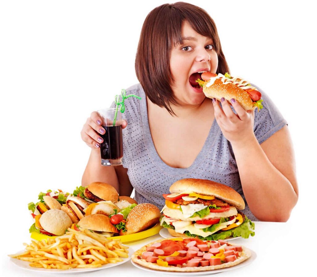 Person overeating junk food after skipping meals